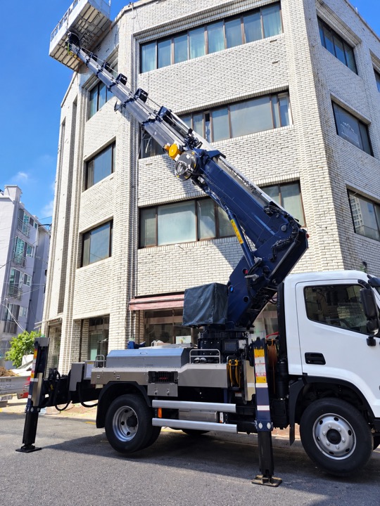 여러 층 건물 앞의 차량과 붐 · 사진 0050